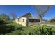 View of backyard featuring home's enclosed porch and mature trees at 4745 W Legrande Ave, Indianapolis, IN 46241