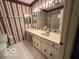 Bright bathroom with vanity, sink, and shower at 7317 Lions Head Dr # 2, Indianapolis, IN 46260