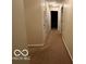 Long hallway with carpeted flooring and access to bedrooms at 7317 Lions Head Dr # 2, Indianapolis, IN 46260
