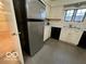 Stainless steel refrigerator in kitchen with cream cabinets and grey flooring at 7317 Lions Head Dr # 2, Indianapolis, IN 46260