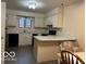 Galley kitchen with light cabinets, stainless steel appliances, and L-shaped counters at 7317 Lions Head Dr # 2, Indianapolis, IN 46260