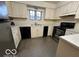 Kitchen with cream cabinets, stainless steel appliances, and grey flooring at 7317 Lions Head Dr # 2, Indianapolis, IN 46260
