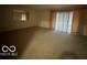 Large living room with wall-to-wall carpet and sliding doors at 7317 Lions Head Dr # 2, Indianapolis, IN 46260