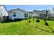 An ample yard space has an outdoor kitchen space with lighting and an ample grassy area at 11218 Boston Way, Fishers, IN 46038