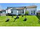 A well-kept backyard boasts an outdoor entertaining area with lights and a view of the home at 11218 Boston Way, Fishers, IN 46038