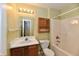 Bathroom features a combination tub and shower and coordinating cabinets at 11218 Boston Way, Fishers, IN 46038