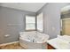 Bathroom featuring a jacuzzi tub, tile floors, and a vanity sink at 11218 Boston Way, Fishers, IN 46038