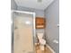 Bathroom featuring a shower stall, toilet, and cabinet at 11218 Boston Way, Fishers, IN 46038