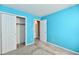 Bright bedroom with turquoise walls, carpet flooring, and closet at 11218 Boston Way, Fishers, IN 46038