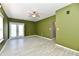 Bright living room featuring tiled floors, a double door exit, and a ceiling fan at 11218 Boston Way, Fishers, IN 46038
