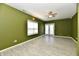 Bright living room featuring tiled floors, a double door exit, and a ceiling fan at 11218 Boston Way, Fishers, IN 46038