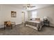 Cozy bedroom with gray bedding, a brown accent chair, and carpeted floors at 1529 Harlan St, Indianapolis, IN 46203