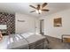Bright bedroom featuring a bed with gray bedding and a ceiling fan at 1529 Harlan St, Indianapolis, IN 46203
