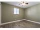 Bright bedroom featuring wood-look floors and ceiling fan at 1529 Harlan St, Indianapolis, IN 46203