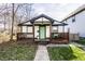 Charming home with a welcoming front porch and light green front door at 1529 Harlan St, Indianapolis, IN 46203