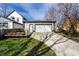 Exterior view of a detached garage with a paved driveway and a charming wooden deck at 1529 Harlan St, Indianapolis, IN 46203