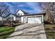 Detached garage with a long driveway, complemented by an adjacent wooden deck at 1529 Harlan St, Indianapolis, IN 46203