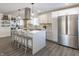 Bright kitchen featuring white cabinets, a large island, and stainless steel refrigerator at 1529 Harlan St, Indianapolis, IN 46203