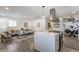 Open living space with kitchen island, gray couch, and hardwood floors at 1529 Harlan St, Indianapolis, IN 46203