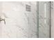 Clean shower with marble-style tile and a glass enclosure at 1529 Harlan St, Indianapolis, IN 46203