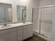 Bathroom boasts double sinks, quartz countertops, and a walk-in shower at 5226 Woodhurst Ln, Indianapolis, IN 46239