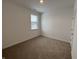 Spacious bedroom with neutral carpeting and a window at 5226 Woodhurst Ln, Indianapolis, IN 46239