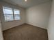 Charming bedroom with neutral carpeting and a window at 5226 Woodhurst Ln, Indianapolis, IN 46239
