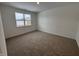 Bright bedroom featuring neutral carpeting and a large window at 5226 Woodhurst Ln, Indianapolis, IN 46239