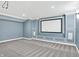 Home theater with large screen and blue walls at 6695 W Deerfield Dr, Zionsville, IN 46077