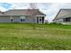 Scenic backyard view featuring lush green lawn, adjacent houses and a screened-in porch at 17345 Northam Dr, Westfield, IN 46074