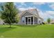 Exterior view of home with a screen porch and a large green lawn under a bright sky at 17345 Northam Dr, Westfield, IN 46074