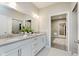 Well-lit bathroom vanity with double sinks, decor, and an open doorway to the carpeted hallway at 17345 Northam Dr, Westfield, IN 46074
