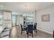 Cozy dining area with stylish chandelier, wood floors, and view into the adjacent kitchen at 17345 Northam Dr, Westfield, IN 46074