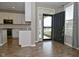 Open entryway featuring hardwood floors, white trim, and view to the kitchen with white cabinets and stainless appliances at 17345 Northam Dr, Westfield, IN 46074