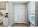 Inviting foyer with natural light, wood floors, and a view to the kitchen, creating a warm welcome at 17345 Northam Dr, Westfield, IN 46074