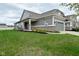 Charming single-Gathering home featuring a manicured lawn, grey siding, and a brick accent, with an attached two car garage at 17345 Northam Dr, Westfield, IN 46074