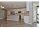 Well-lit kitchen with white cabinets, stainless steel appliances, an island, and hardwood flooring for a modern appeal at 17345 Northam Dr, Westfield, IN 46074