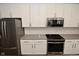 Kitchen showcasing stainless steel appliances, white cabinets, stylish hardware, and tile backsplash with gray counter tops at 17345 Northam Dr, Westfield, IN 46074