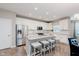 Bright kitchen with white cabinets, stainless steel appliances, and an island with barstool seating at 17345 Northam Dr, Westfield, IN 46074
