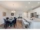 Open-concept kitchen and dining area boasts a large island with bar seating and elegant chandelier at 17345 Northam Dr, Westfield, IN 46074