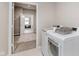 Convenient laundry room featuring modern washer and dryer units with easy access to the home at 17345 Northam Dr, Westfield, IN 46074