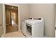 Bright laundry area features new appliances and ceramic tile floor at 17345 Northam Dr, Westfield, IN 46074