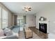 Bright living room with a fireplace, neutral tones, and sliding door to a balcony for relaxation at 17345 Northam Dr, Westfield, IN 46074
