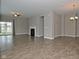 Spacious living room with hardwood floors, a ceiling fan, a cozy fireplace, and sliding glass doors for natural light at 17345 Northam Dr, Westfield, IN 46074