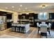 Modern kitchen with dark cabinets, granite counters, and stainless steel appliances at 2215 Dorothea Ct, Greenwood, IN 46143