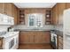 Kitchen with wood cabinets, granite countertops, and white appliances at 5815 N Washington Blvd, Indianapolis, IN 46220