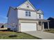 Handsome two-story home featuring gray siding, brick facade, covered porch, and a pristine front yard at 6196 Granby Dr, Whitestown, IN 46075