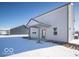 Rear view of house showcasing covered patio and snowy yard at 6196 Granby Dr, Whitestown, IN 46075
