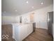 Modern kitchen with island, stainless steel appliances, and hardwood floors at 6196 Granby Dr, Whitestown, IN 46075
