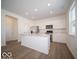 Modern kitchen with island, stainless steel appliances, and hardwood floors at 6196 Granby Dr, Whitestown, IN 46075
